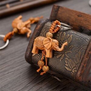 Carved elephant wood grain key chain. New.